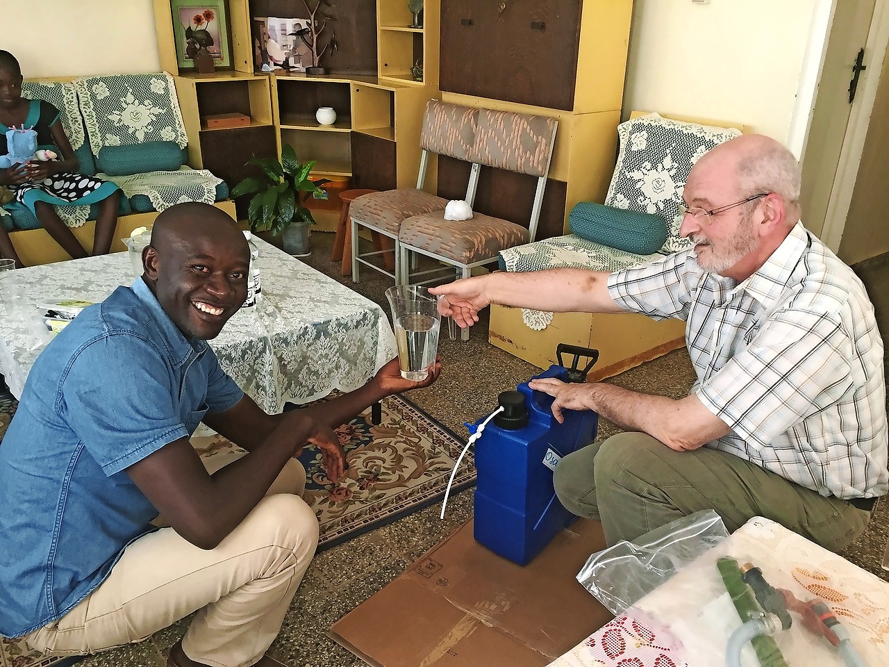 Luc Lefevere (rechts) demonstreert een eenvoudige waterfilter. © Osafi