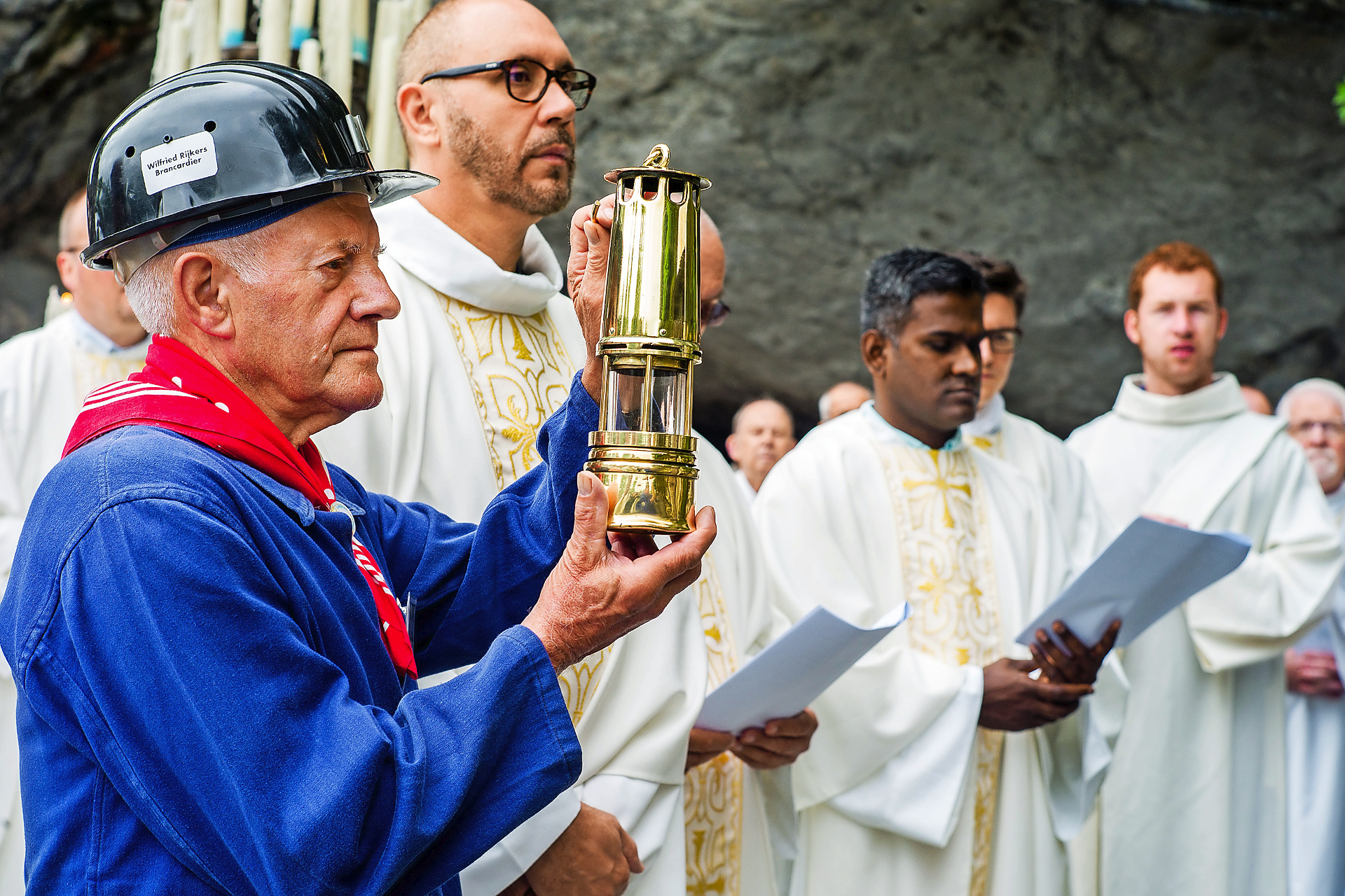 Een mijnwerkerbrancardier in typische kledij aan de grot in Lourdes. © Photo Lacaze